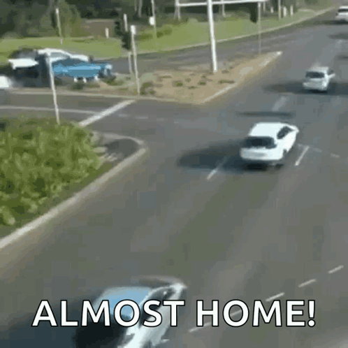 A Busy Street With The Words " Almost Home " On The Bottom Right GIF