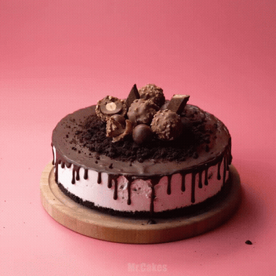 A Cake On A Wooden Cutting Board That Says Mr.cakes On It GIF