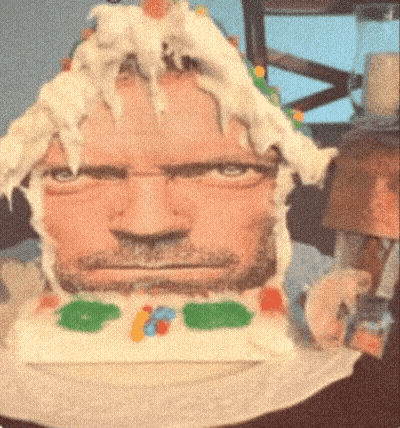 A Cake That Looks Like A Man 'S Face With A Beard On It GIF