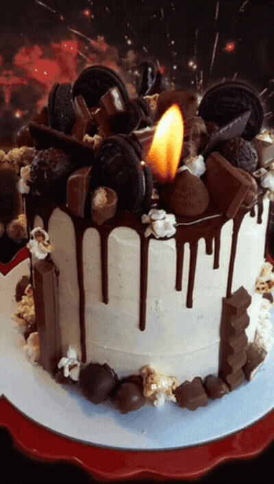 A Cake With A Candle On Top Of It That Says Oreo On It GIF