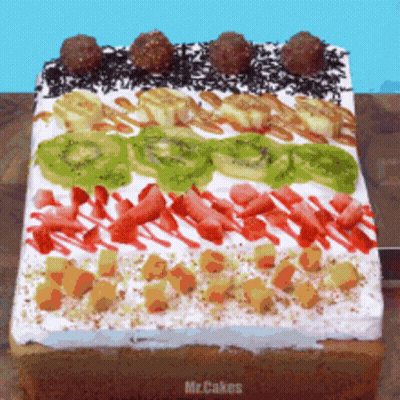 A Cake With Kiwi Bananas Strawberries And Chocolate Sprinkles GIF