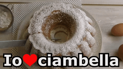 A Cake With Powdered Sugar On It And The Words Io Ciambella Above It GIF