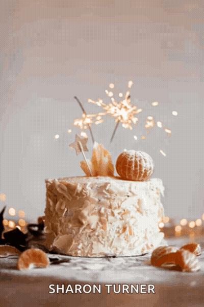 A Cake With Sparklers On Top Of It And The Name Sharon Turner GIF
