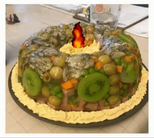 A Cake With Vegetables And A Fire On Top GIF