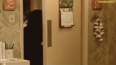 A Calendar Is Hanging On The Wall Next To A Door GIF