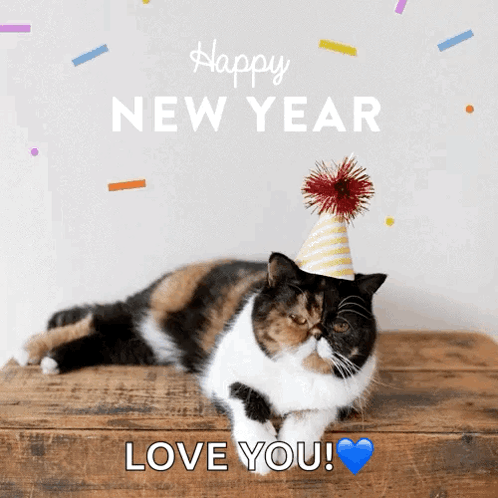 A Calico Cat Wearing A Party Hat Laying On A Wooden Table With The Words Happy New Year Love You GIF