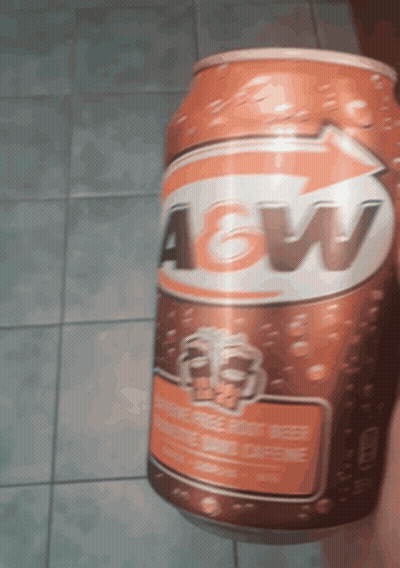 A Can Of A&w Root Beer Is Being Held By Someone GIF