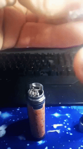 A Can Of Soda Sits On A Blue Surface In Front Of A Computer Keyboard GIF