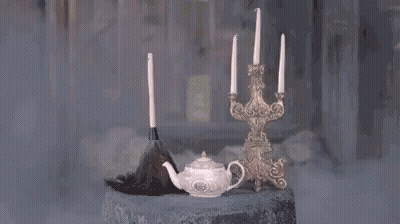 A Candle Is Being Lit In A Room With Smoke Coming Out Of It And A Candle Holder . GIF