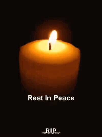 A Candle Is Lit In The Dark With The Words `` Rest In Peace '' Written Below It . GIF
