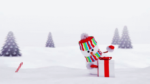 A Candy Cane Is Laying On The Ground In Front Of A Christmas Tree GIF