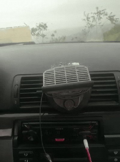 A Car Dashboard With A Sony Radio And A Fan Attached To It GIF