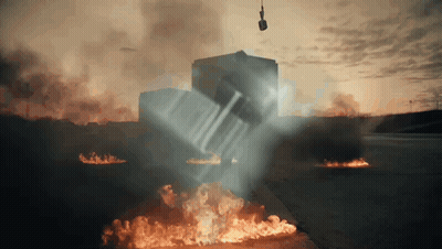 A Car Is Being Lifted Into The Air By A Crane GIF