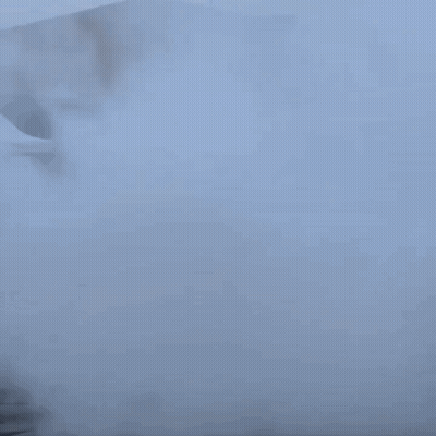 A Car Is Doing A Burnout In A Parking Lot With Smoke Coming Out Of It GIF