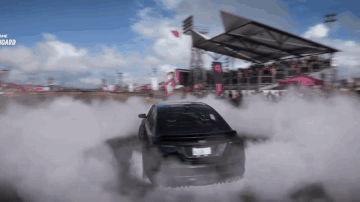 A Car Is Drifting In Front Of A Crowd And The Word Board Is Visible In The Background GIF