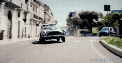 A Car Is Driving Down A City Street With The Year 2022 On The Bottom Right GIF