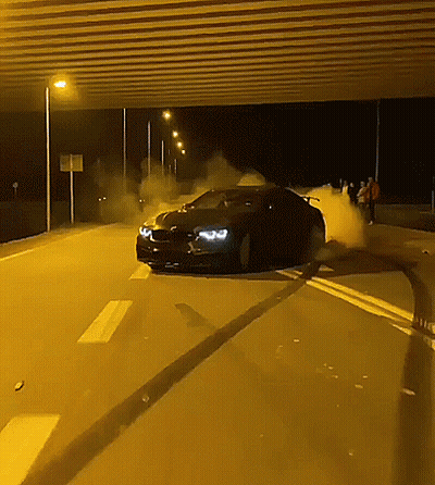 A Car Is Driving Down A Highway At Night GIF