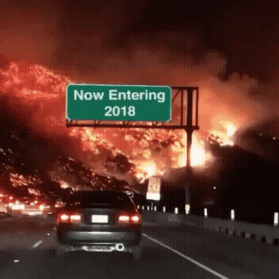 A Car Is Driving Down A Highway In Front Of A Sign That Says Now Entering 2018 GIF