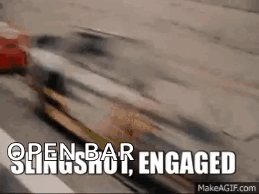 A Car Is Driving Down A Highway With The Words `` Open Bar Slingshot Engaged '' Written Above It . GIF