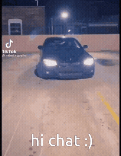 A Car Is Driving Down A Parking Lot At Night And The Caption Says Hi Chat . GIF