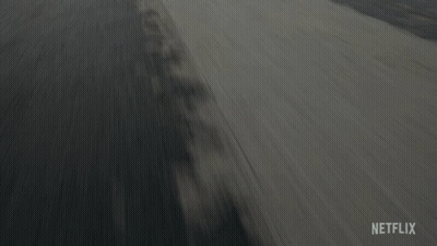 A Car Is Driving Down A Road With A Netflix Logo On The Bottom Right GIF
