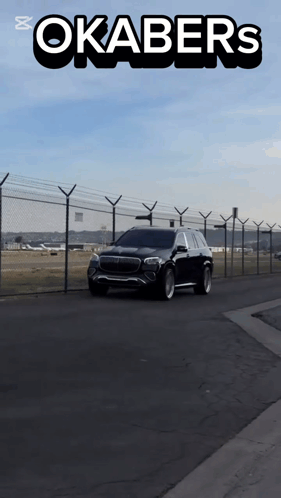 A Car Is Driving Down A Road With Okabers Written On The Top GIF