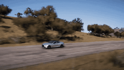 A Car Is Driving Down A Road With Trees On The Side Of It GIF