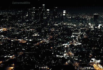 A Car Is Driving Down A Street With A Sign That Says Extremeblitz On It GIF