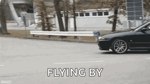 A Car Is Driving Down A Street With The Words " Flying By " Written On The Bottom GIF