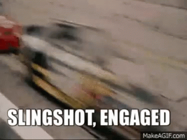 A Car Is Driving Down A Street With The Words `` Slingshot , Engaged '' Written On It . GIF