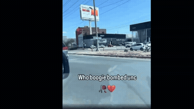 A Car Is Driving Down A Street With The Words Who Boogie Bombed Unc Written On The Windshield GIF