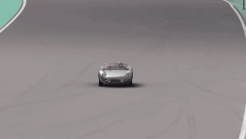 A Car Is Driving On A Race Track With A Wall That Says Project On It GIF