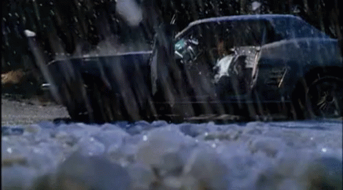 A Car Is Driving Through A Snowy Area With Ice On The Ground GIF