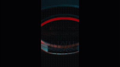 A Car Is Parked In Front Of A Building In The Dark GIF