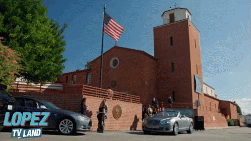 A Car Is Parked In Front Of A Building That Says Lopez Tv Land On The Bottom GIF