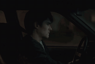 A Car Is Parked In Front Of A House With A Picture Of A Man And The Words True On It GIF