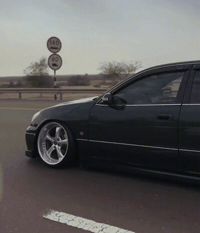 A Car Is Parked In Front Of A Sign That Says 140 And 80 GIF