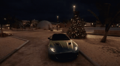 A Car Is Parked Next To A Christmas Tree At Night GIF