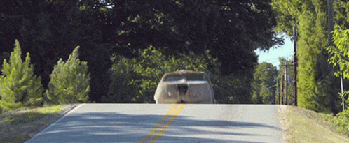 A Car Is Parked On The Side Of A Road GIF