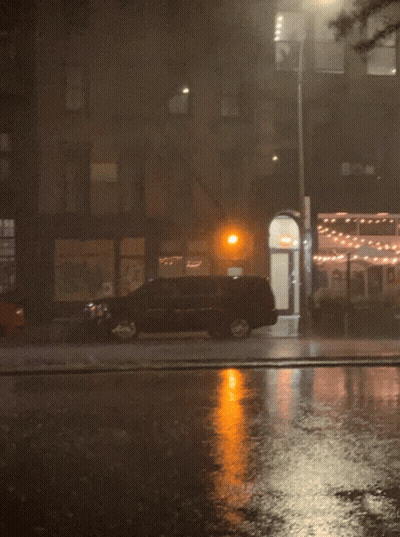 A Car Is Parked On The Side Of The Road In Front Of A Building GIF