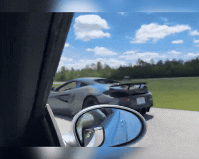 A Car Is Parked On The Side Of The Road With A Rear View Mirror GIF