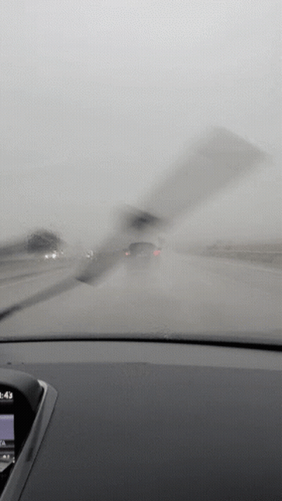 A Car Windshield Wiper Is Being Used To Clean The Windshield Of A Car GIF