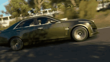 A Car With A Cross On The Side Is Driving Down The Road GIF