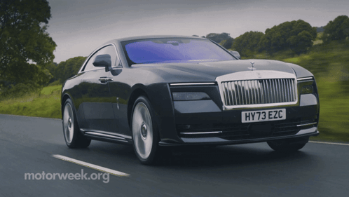 A Car With A License Plate That Says Hy73 Ezc Is Driving Down A Road GIF