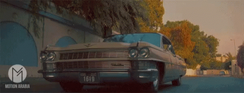 A Car With A License Plate That Says L610 Is Driving Down A Street GIF