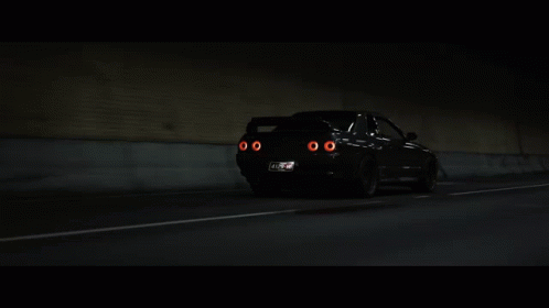 A Car With A License Plate That Says ' Nz ' On It Is Driving Through A Tunnel GIF