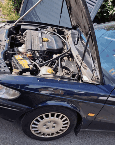 A Car With The Hood Open Has A Yellow Battery In It GIF