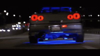 A Car With The Number 00 On The Back Is Driving Down The Road GIF