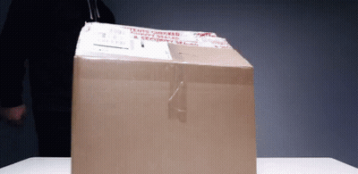 A Cardboard Box With A Sticker On It That Says ' Fragile ' GIF
