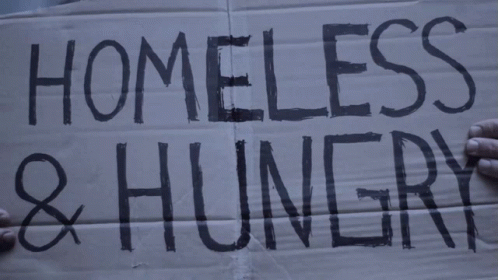 A Cardboard Sign That Says Homeless And Hungry GIF
